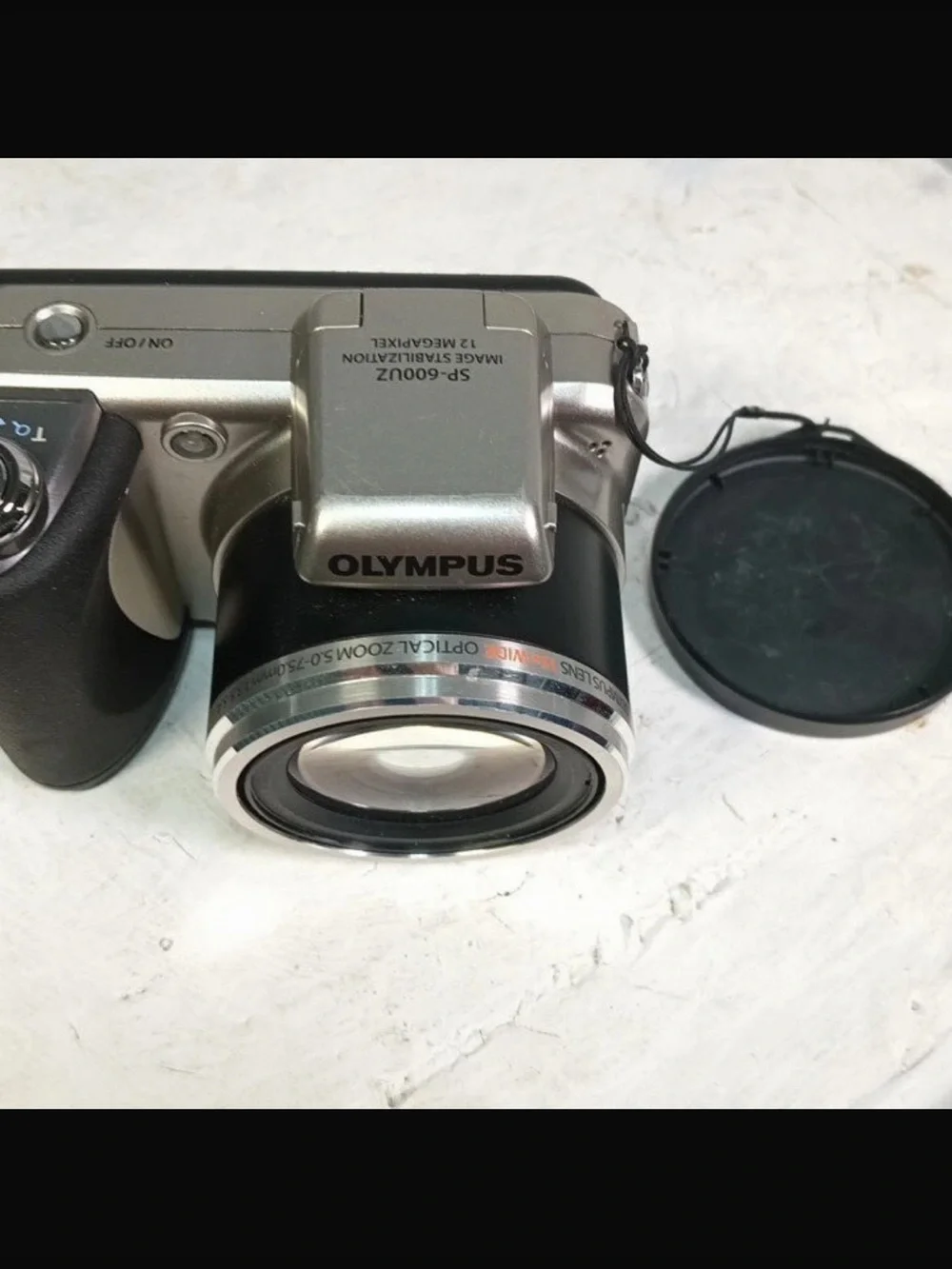 Olympus Silver Digital Camera with Black Grip and Lens Cap